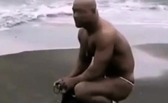 Asian bodybuilder barely covered at the beach