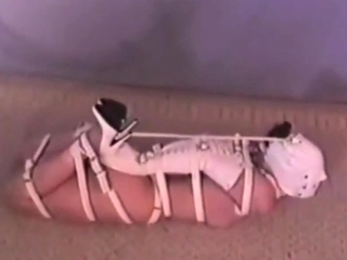 Hogtied Ashley struggling on the floor